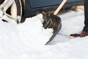 Shovelling snow from car